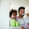 Man Brushing Child's Teeth
