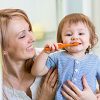 Mother Holding Son Brushing Teeth